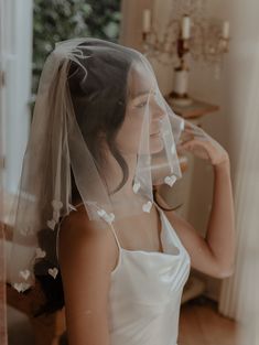 a woman in a wedding dress wearing a veil