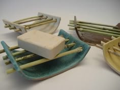 three different types of toothbrushes sitting next to each other on a plate with bamboo handles