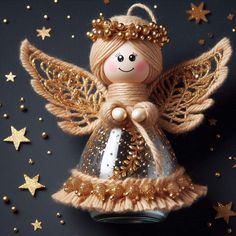 an angel ornament with gold stars around it