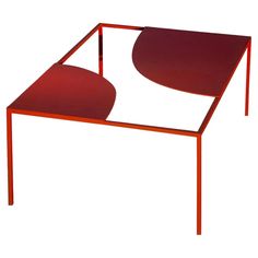 a red table sitting on top of a white floor