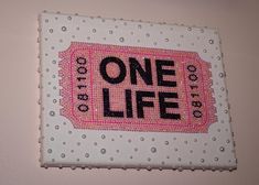 a one life sign hanging on the side of a wall in a room with polka dots