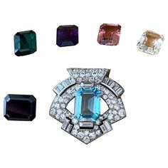 AN ART DECO DIAMOND DOUBLE CLIP BROOCH, BY OSTERTAG, 1930s, Of stylised shield outline, with pave-set brilliant cut Diamonds and Baguette Diamonds. The brooch features a square centre stone that is interchangebale. Blue Topaz 8.45 ct, white Crystal Quartz 7.35 ct, Amethyst 6.95, Tourmaline 7.50 ct, Onyx 9.90 ct and pink Topaz 7.65 ct. Dimensions: 3.50 cm x 3.30 cm. Weight without centre gemstone: 13.25 grams. The brooch can also be worn with a 18 K white Gold multistand necklace, 25.40 grams. Th Shield Outline, Gemstone Art, Baguette Diamonds, Diamond Brooch, Pink Topaz, Antique Vintage Jewelry, Harry Winston, French Art Deco, Jewelry Pins