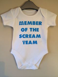 a white bodysuit with blue writing on it that says, member of the scream team