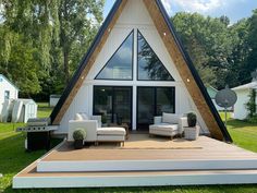 a - frame house with an outdoor deck and seating area