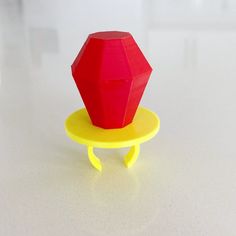 a red object sitting on top of a yellow plate