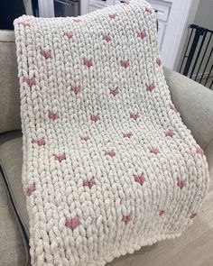 a crocheted blanket sitting on top of a couch