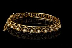 "This is a very beautiful, vintage and unique PEARLS 14K GOLD c. 1970 bangle bracelet (weight 22.1g). The bracelet has a marvelous and chic style, rope filigree ornament with 11 white luster pearls (2.5 mm) and 14K gold (bottom has 14K). The bracelet has a very extravagant and elegant feel to it. It measures size 6 1/2\" x 5/16\". The bracelet is in very good condition. 0.7 GLM" Luxury Victorian Gold Bracelet For Anniversary, Luxury Victorian Gold Bracelet With Intricate Design, Vintage Yellow Gold Pearl Bracelet For Wedding, Vintage Yellow Gold Pearl Bracelet For Formal Occasions, Elegant Pearl Bracelet With Intricate Design For Wedding, Elegant Pearl Bracelet For Wedding With Intricate Design, Elegant Wedding Pearl Bracelet With Intricate Design, Vintage Gold Pearl Bangle Bracelet, Fine Jewelry Pearl Bangle Bracelet For Wedding