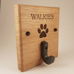 a wooden sign that says walkies with a paw print on the front and side