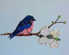 a blue bird sitting on top of a tree branch with lots of buttons attached to it