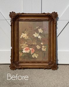 an old frame with flowers painted on it next to a garage door that says before