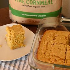 two pieces of cake on a plate next to a bag of fine cornmeal