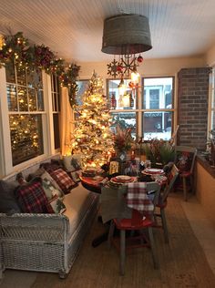 a living room with a christmas tree in the corner and other decorations on the windowsill