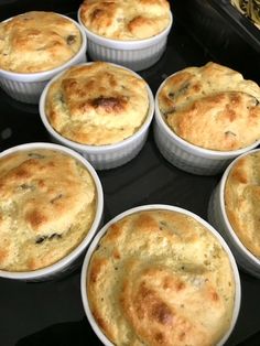 six white bowls filled with food sitting on top of a stove