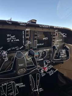 an airplane cockpit with various controls and writing on it