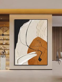 an abstract painting hangs on the wall in a modern living room