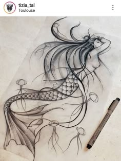 a drawing of a woman with long hair and a fish on her back, sitting next to a pen