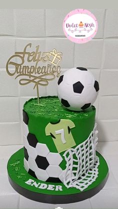 a soccer themed cake with a goal and ball on top