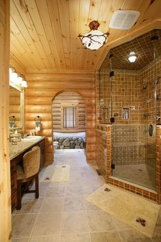 a large bathroom with a walk in shower next to a sink and mirror on the wall