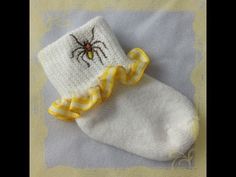 a small white sock with a spider on it