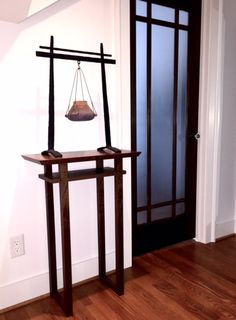 an empty room with a wooden floor and glass door that has a weight scale on it