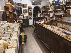 a store filled with lots of different types of boxes and books on shelves next to each other