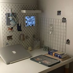 a laptop computer sitting on top of a white desk