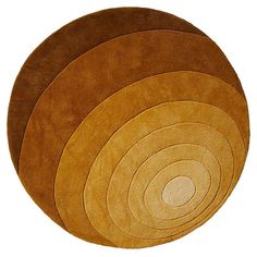 four round rugs in various colors on a white background