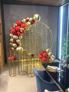 a dining room table with chairs and balloons on the wall in front of it,