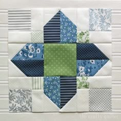 a patchwork quilt with blue and green blocks