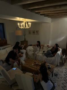 three people sitting on couches in a living room