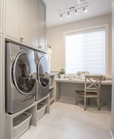 a washer and dryer in a room with white carpeted flooring on the walls