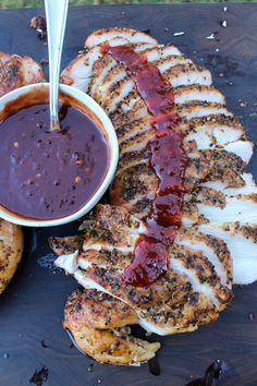 grilled chicken with bbq sauce and baked potato wedges on a cutting board