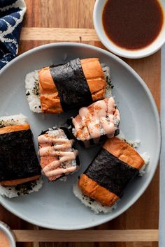 sushi on a plate with dipping sauce and chopsticks