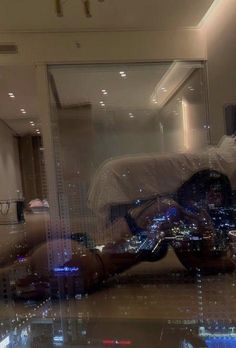 the reflection of a person taking a selfie in front of a mirror with city lights on it