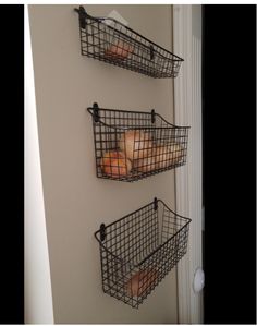 two metal baskets filled with food hanging on a wall