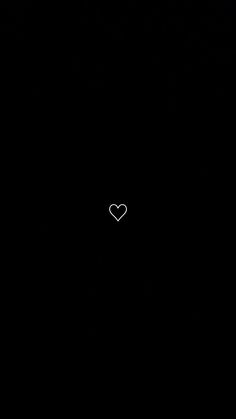 a black background with a white heart in the middle and small dots on the bottom