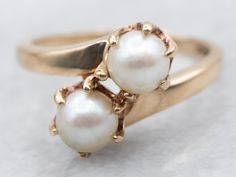 This vintage saltwater pearl ring has a classical bypass style that is timeless! The pearls sit in the center of curving, polished heads in gleaming yellow gold. Easy to wear day or night, this vintage ring is elegant and beautiful. Metal: 10K Yellow GoldGem: 2 Saltwater PearlsGem Measurements: 5.2 mm, RoundRing Size: 5.50Marks: "10K B&F" Stamped on the inside band White Pearl Ring, Pearl Birthstone, Ring Pearl, Gold Pearl Ring, Saltwater Pearls, Bypass Ring, Gold Gift, Round Rings, Vintage Ring