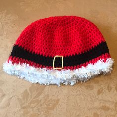 a red and black knitted hat with white trim