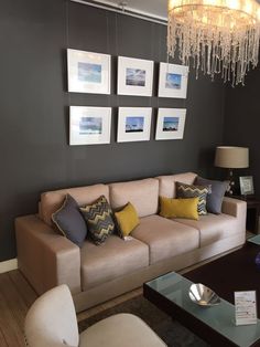 a living room filled with furniture and pictures on the wall