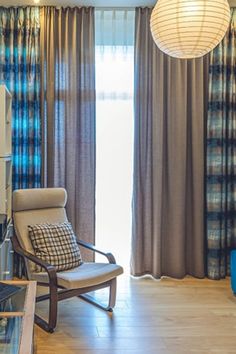 a living room filled with furniture and curtains