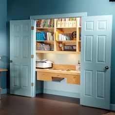 an open door leading to a desk and bookshelf in a room with blue walls