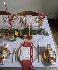 the table is set with place settings for dinner