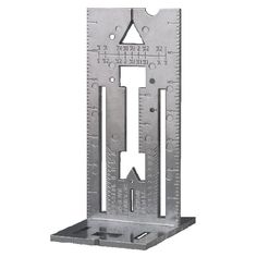 a metal ruler with an arrow on the bottom and two holes in the middle for measuring