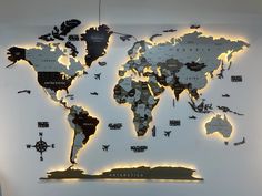 the world map is lit up in white with black and gold accents on it's sides