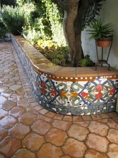 an outdoor bathtub in the middle of a patio with potted plants on either side