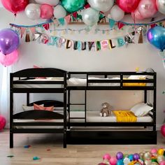 a room filled with balloons and bunk beds