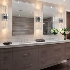 a large bathroom with double sinks and mirrors