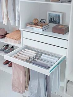 an organized closet with clothes and shoes on the shelves, including one open drawer that holds several pairs of shoes