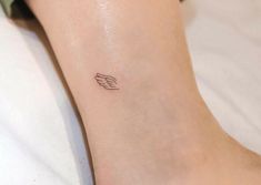 a small wing tattoo on the ankle