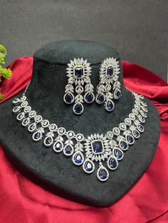 Gorgeous fine quality replica diamond and faux Sapphire blue studded necklace with a white  rhodium plating and matching Earrings Item contains: Necklace and earrings AAA-quality cubic zirconia was used. Highest quality and craftsmanship Necklace Fitting is adjustable Earrings Closure: Pushback Necklace Closure: chain with Hook Blue Cubic Zirconia Jewelry For Celebration, Blue Round Bridal Necklace For Celebration, Traditional Blue Bridal Necklace For Formal Occasions, Sapphire Diamond Jewelry For Party, Blue Cubic Zirconia Round Bridal Necklace, Dazzling Blue Diamond Cut Jewelry, Dazzling Blue Diamond-cut Jewelry, Party Jewelry With Sapphire And Diamond, Blue Cubic Zirconia Bridal Necklace